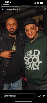 two men standing next to each other on a phone screen