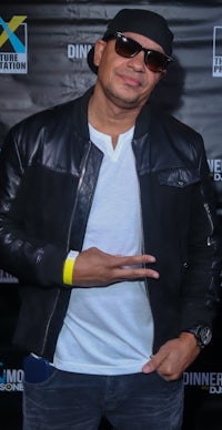 a man wearing a black jacket and sunglasses